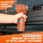 Person using an orange cordless drill on a metal surface.