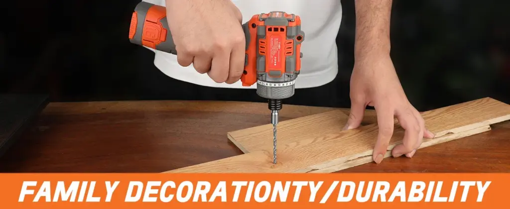 Person using an orange cordless drill on a wooden board.