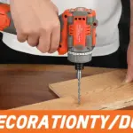 Person using an orange cordless drill on a wooden board.