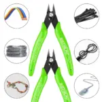 Green wire cutters surrounded by various wires and cables.