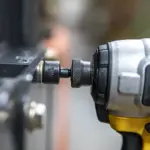 Close-up of a power drill tightening a bolt.