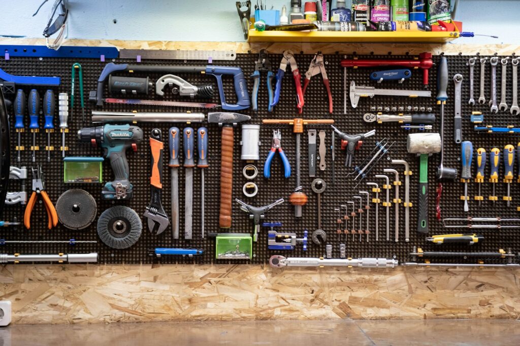 A bunch of hand tools hanging up on a wall
